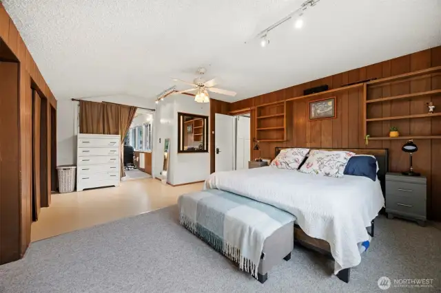 Looking across the primary bedroom toward the office or sun room.