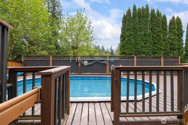 The swimming pool is fenced off and surrounded by decking.
