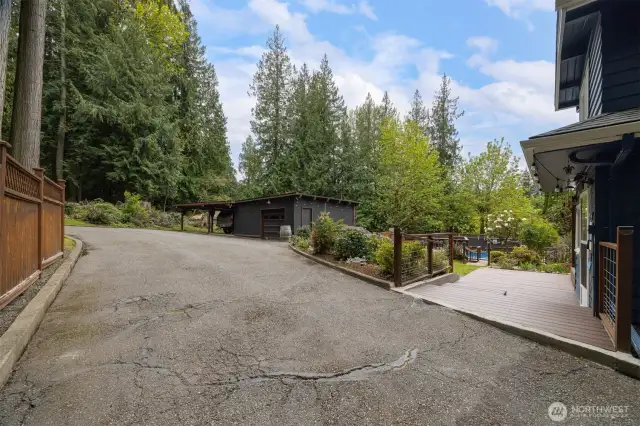 Look at all the parking and turnaround area there is beyond the home that has towering evergreens and lots of privacy.
