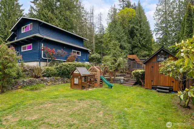 The lower front yard has a play area and there is a new pump house for the pool.