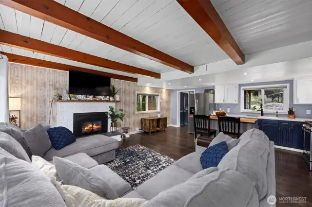 The living room is open to the kitchen and dining area and the wood ceilings with large cedar beams give the home a warm, cottage-type feeling. The gas fireplace is wonderful on those chilly winter days and evenings.