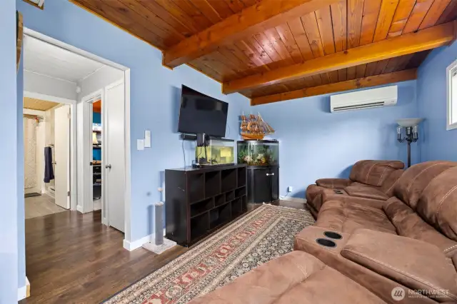 Another view of the family room with the hallway that leads to a main floor bedroom and a full bath.