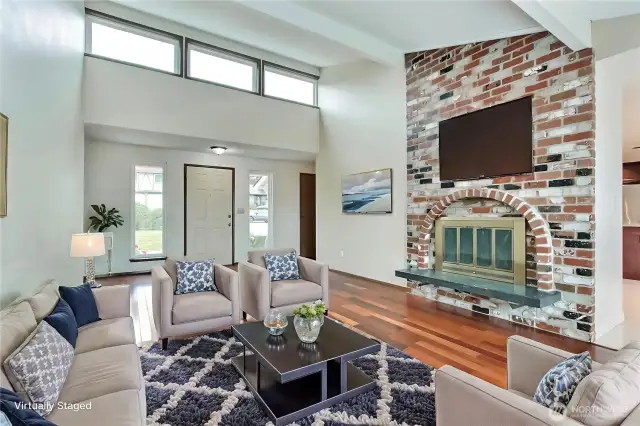 Main floor living area with wood burning fire place, Cherry floors