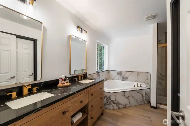 Your primary bathroom has two sinks and a soaking tub.