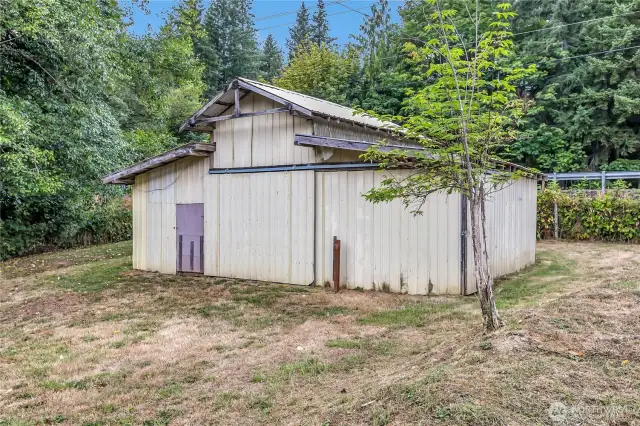 Barn on right side of property with cement floor and power.