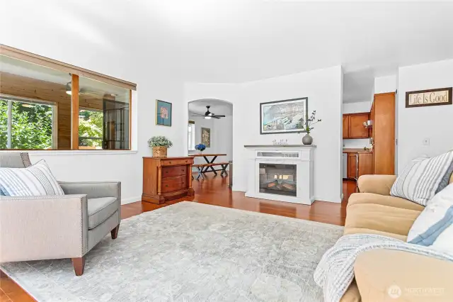 The living room is just off the kitchen and dining area, and has a cozy electric fireplace