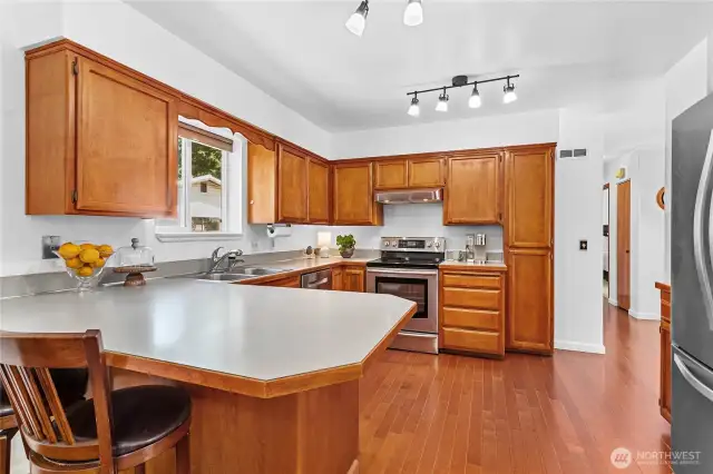 The light and bright kitchen has stainless steel appliances
