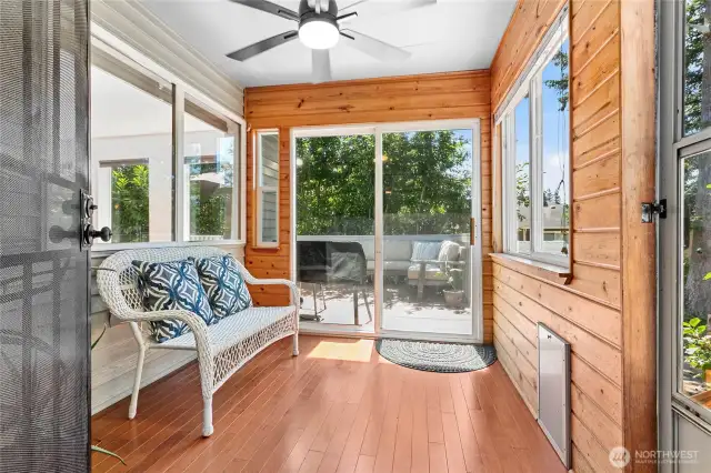 The sunroom is a perfect spot for morning coffee, with a great view of the private backyard! It has a sliding door to the deck and a separate entrance with steps down to the backyard.