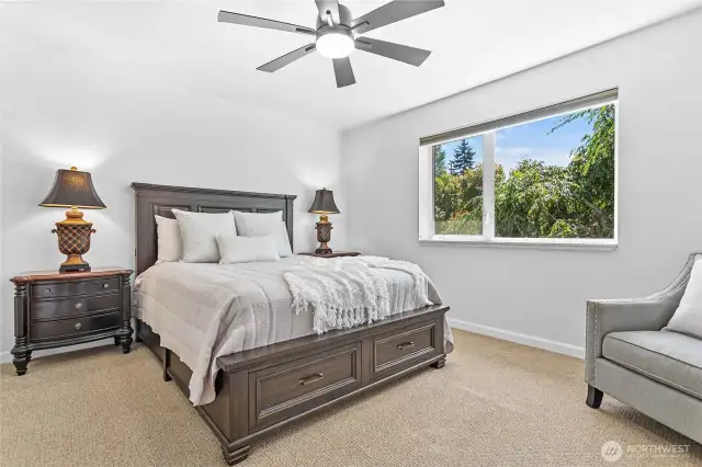 The spacious primary bedroom is light and bright