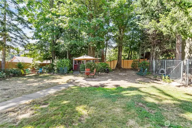 The backyard is fully fenced with 2 gates, one on each side of the house, and a dog run/kennel. A large section of the back fence panel in new!