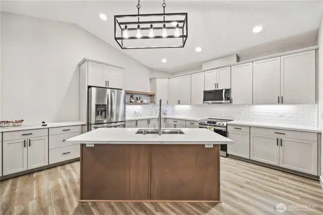 Ample counter space, cupboards & storage for all your cooking needs.  Sink and dishwasher in island makes cleanup easy.  Add bar stools for additional seating.