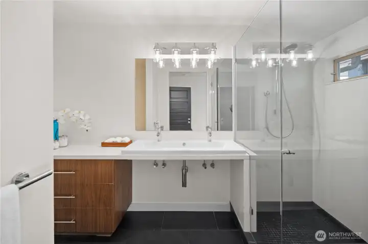 3/4 bathroom with dual sinks in the primary bedroom