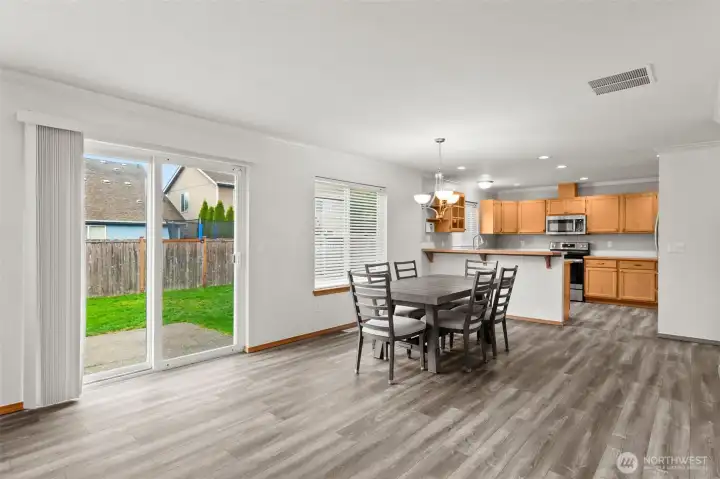 Looking from the family/great room toward the dining area an open kitchen.