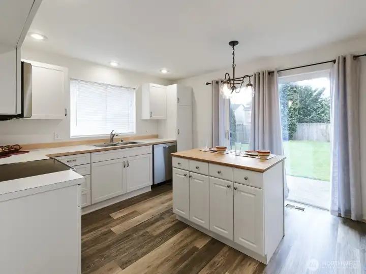 So much natural light!  Beautiful, private backyard.   Back of property borders road, but sits high above it, so foot traffic & cars have no view into yard.  Mature plantings.