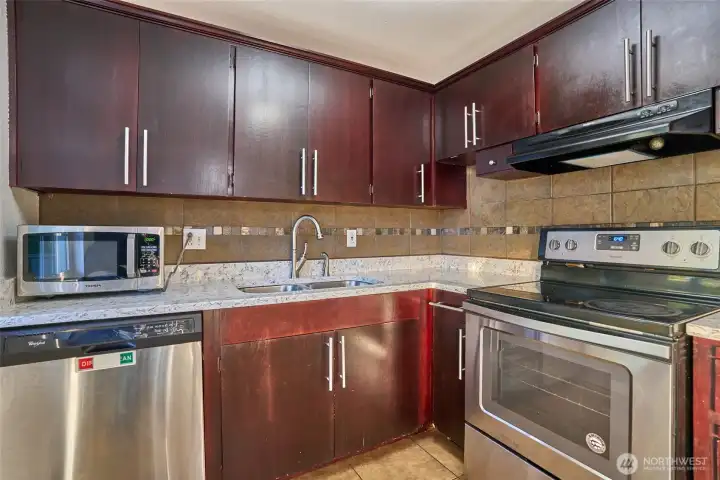 Chef's Kitchen with Granite Countertops, Stainless Steel Appliances, Granite Countertops, Tile Backsplash and Tile Floors. New Dishwasher.