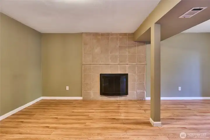 Downstairs Family Room with Tile Surround Wood Fireplace.