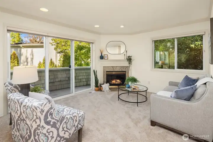 Inviting formal living room off the entry with gas fireplace and private balcony