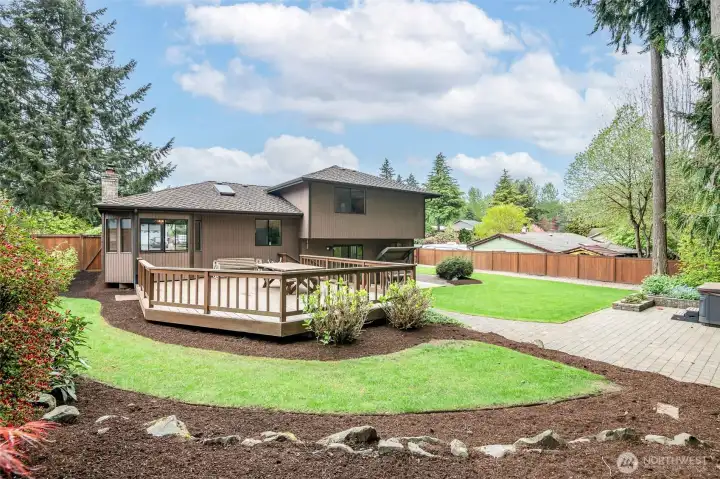 Back yard with beautiful pavers to the hot tub.