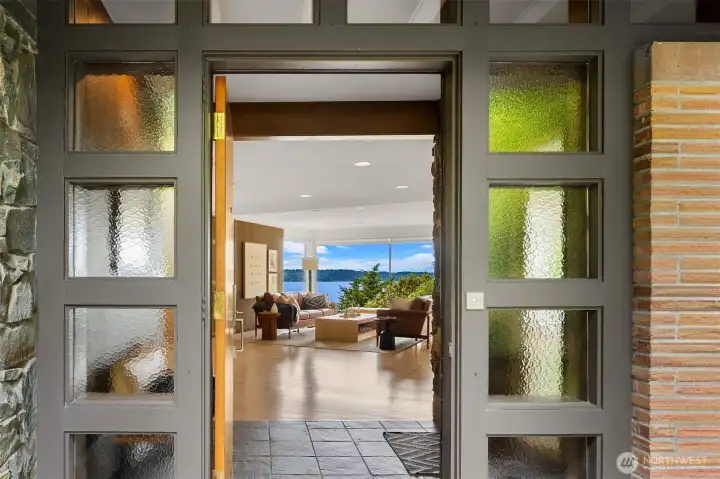 Main entry opens to view of Puget Sound from panoramic windows of the living room Main entry opens to view of Puget Sound from panoramic windows of the living room