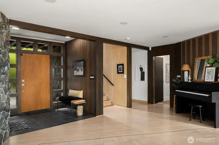 View towards the entry and staircase with original Midcentury features including original solid wood paneling. View towards the entry and staircase with original Midcentury features including original solid wood paneling.