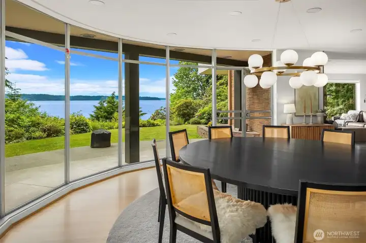 Circular dining room with solid wood paneling and floor to ceiling windows to Puget Sound. Circular dining room with solid wood paneling and floor to ceiling windows to Puget Sound.