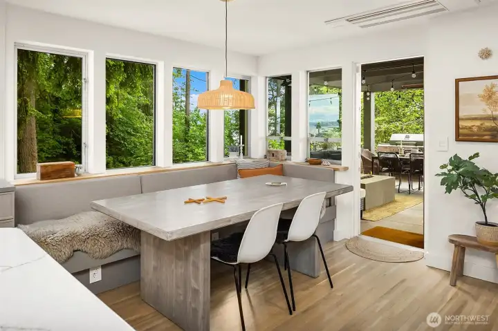 Kitchen has breakfast nook with built-in bench seating and views to Puget Sound and access to west facing covered patio space with fire table. Kitchen has breakfast nook with built-in bench seating and views to Puget Sound and access to west facing covered patio space with fire table.