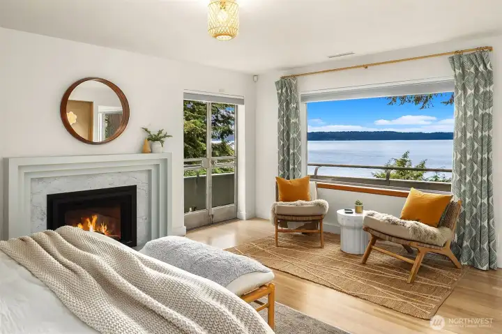 Primary suite with view of Puget Sound and access to wrap around balcony. Remote controlled gas fireplace. Primary suite with view of Puget Sound and access to wrap around balcony. Remote controlled gas fireplace.