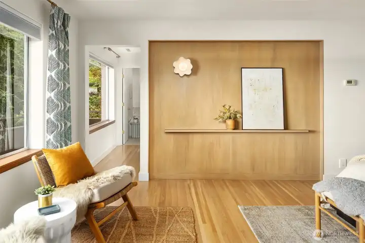 Primary suite feature-wall with solid white oak paneling and custom ceramic wall sconce and gallery ledge. Primary suite feature-wall with solid white oak paneling and custom ceramic wall sconce and gallery ledge.
