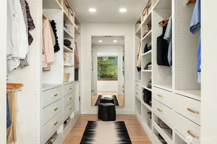 Walk-in closet with his and her closet sides and large mirror. Outlets and automatic on/off lighting. Walk-in closet with his and her closet sides and large mirror. Outlets and automatic on/off lighting.