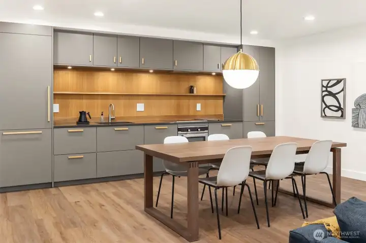 A second full kitchen with dining area in the family room. Paneled fridge/freezer and dishwasher. Coffee bar cabinet / microwave with solid counter and automatic lights. A second full kitchen with dining area in the family room. Paneled fridge/freezer and dishwasher. Coffee bar cabinet / microwave with solid counter and automatic lights.