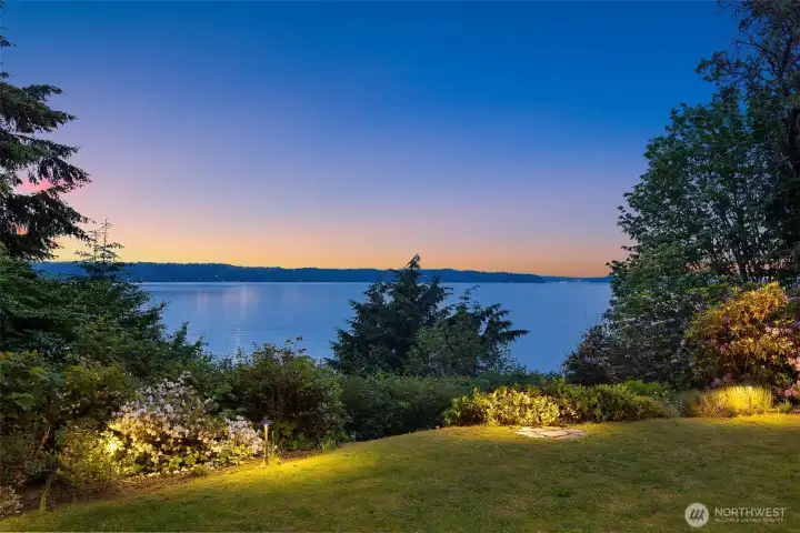 Landscape lights and view from the back yard to Puget Sound in the evening. Landscape lights and view from the back yard to Puget Sound in the evening.