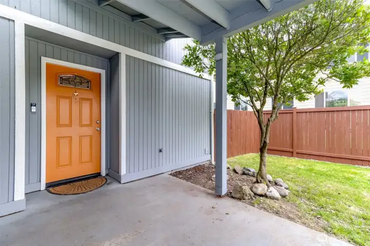 Fully covered entry from garage or carport into your new home along with a fully fenced backyard with a gate just to the right of the home.