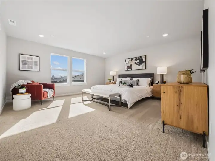Primary bedroom with large picture windows. Pictures are for representational purposes only. Finishes vary.