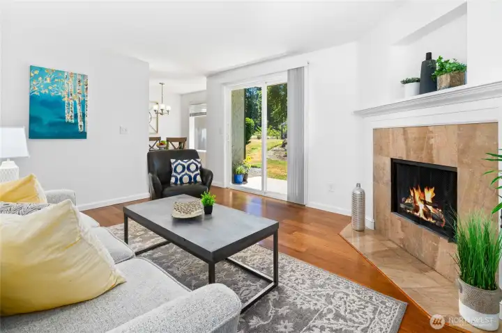 Wood-burning fireplace and sliding glass door in living room.