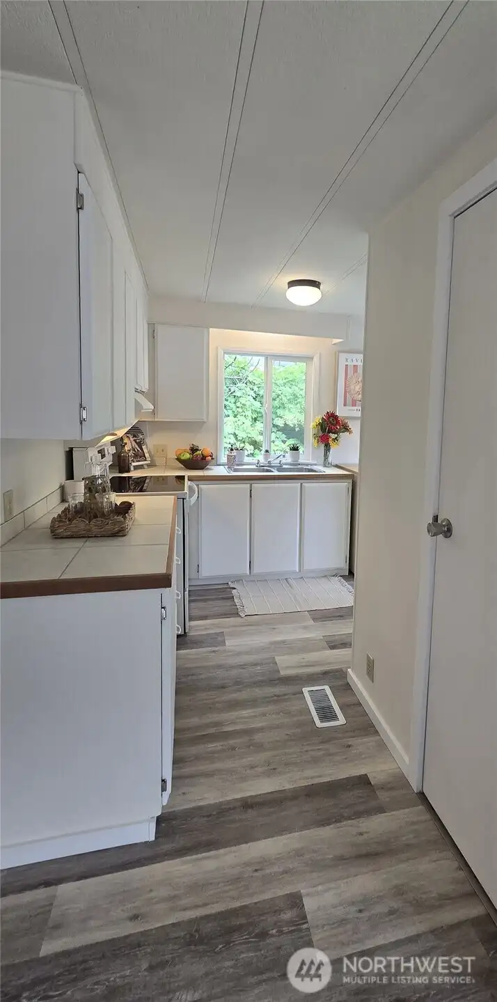New countertops are tile with wood trim