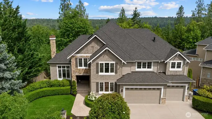 Striking two-story front exterior with stone accents and lush landscaping