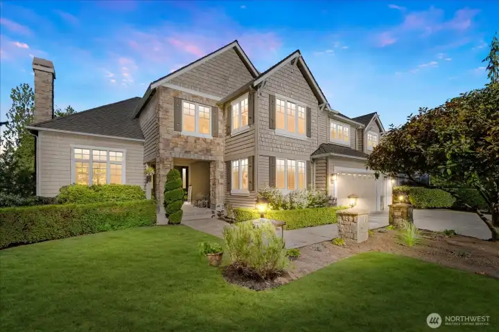 Beautiful curb appeal with mature landscaping and manicured lawn