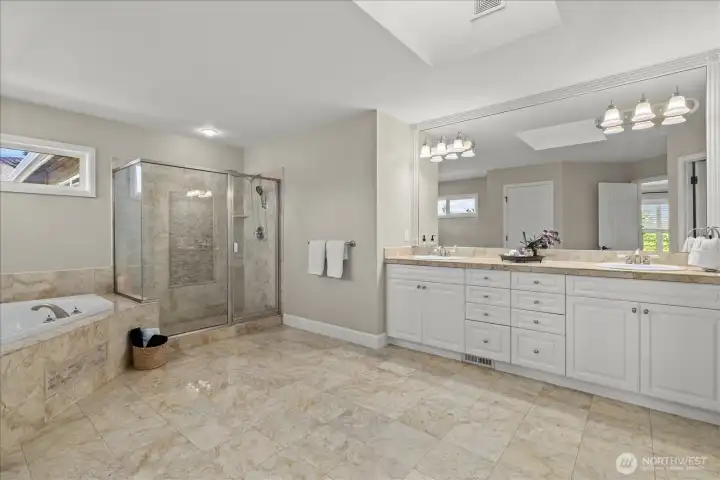 Luxurious bathroom with dual vanity and walk-in shower