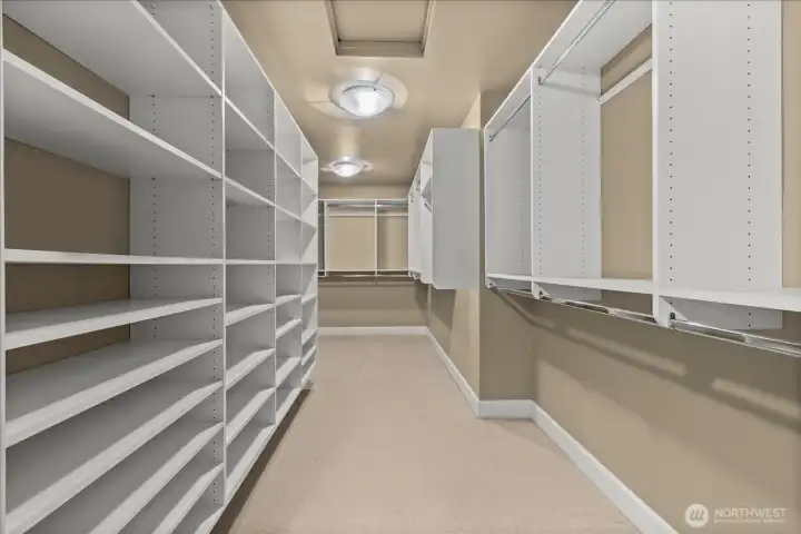 Generous walk-in closet with custom shelving