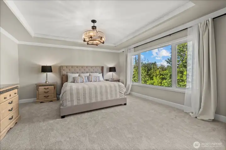 Serene primary suite with large windows and en-suite access