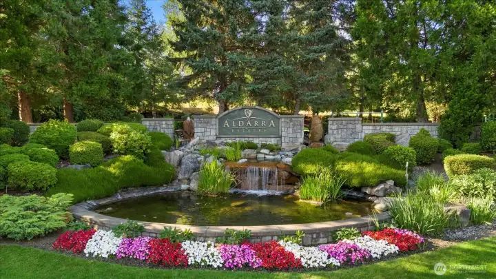 Aldarra community entrance with landscaped pond and water feature