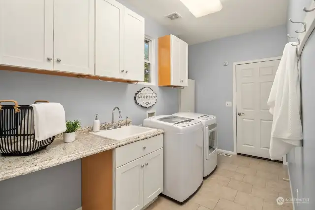 From the garage, you enter this laundry and mud room with plenty of storage.