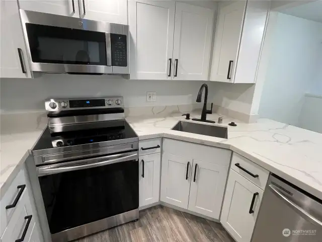 A large farmhouse sink enhances the modern aesthetic while offering exceptional convenience, making cleanup a breeze after preparing a gourmet meal.