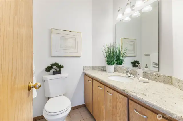 Main floor 1/2 bath, just off mudroom entry from garage.