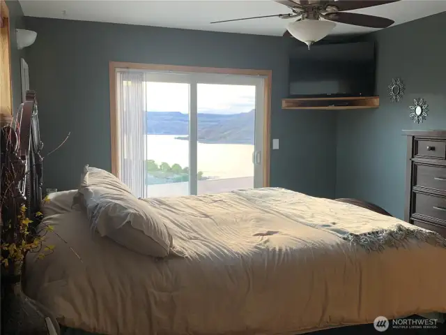 Wake up in the primary bedroom with slider to deck and patio