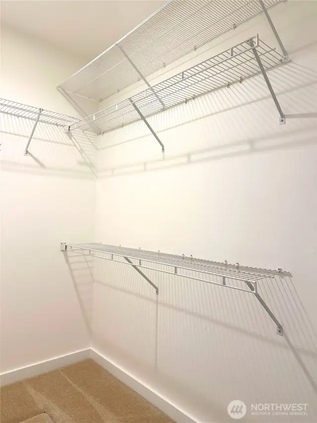 The spacious walk-in closet in the primary bedroom.