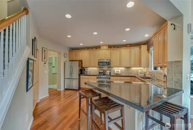 42" upper cabinets with under cabinet lighting, a full pantry to the left, lots of counter space and casual seating.