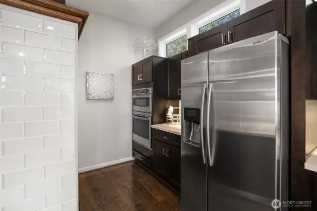 Double ovens with top oven doubling as a microwave. Note: Spacious pantry cabinets are directly across for the oven area.