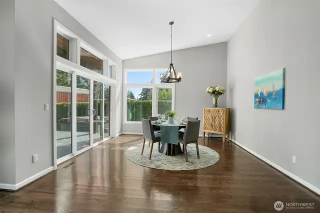 Large dining area with vaulted ceiling and sliders to covered deck, perfect for year round BBQing.