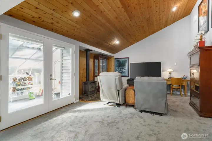 Looking from the breakfast area toward the family/TV area. French doors at left lead into the solarium.